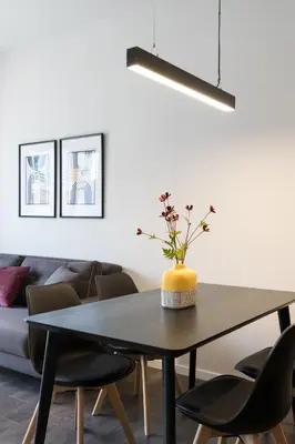 a dining room table with chairs and a light fixture at Voda Luxury Residence #502 - Acropolis View Rooftop in Athens