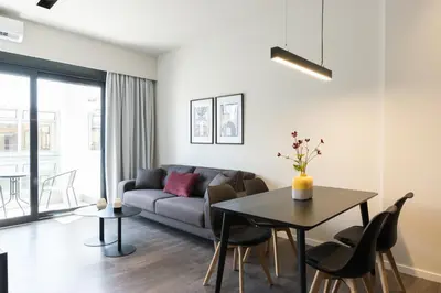 a living room with a couch and a table at Voda Luxury Residence #502 - Acropolis View Rooftop in Athens