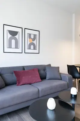 a living room with a blue couch and a table at Voda Luxury Residence #502 - Acropolis View Rooftop in Athens