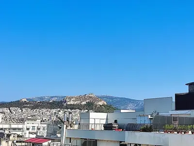 a view of a city with mountains in the background at Voda Luxury Residence #502 - Acropolis View Rooftop in Athens