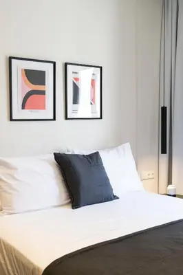 a bedroom with a bed with two pictures on the wall at Voda Luxury Residence #502 - Acropolis View Rooftop in Athens