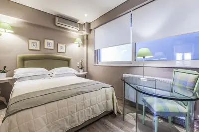a bedroom with a bed and a glass table at Luxury Acropolis View Duplex Penthouse in Thiseio 155m2 in Athens