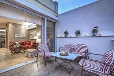 a living room with chairs and a table at Luxury Acropolis View Duplex Penthouse in Thiseio 155m2 in Athens