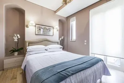 a bedroom with a large bed with a blue blanket at Luxury Acropolis View Duplex Penthouse in Thiseio 155m2 in Athens