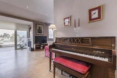 a living room with a piano and a television at Luxury Acropolis View Duplex Penthouse in Thiseio 155m2 in Athens