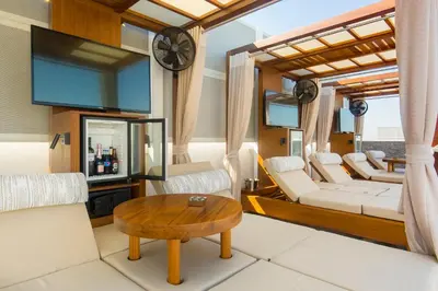 a living room with white furniture and a table at Airotel Alexandros in Athens