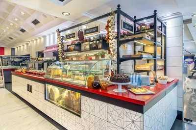 a bakery counter with a lot of food on it at Airotel Alexandros in Athens