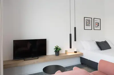 a living room with a tv and a bed at Voda Luxury Residence Penthouse #601 - Acropolis View Rooftop in Athens