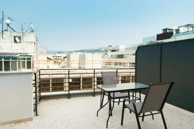 a table and chairs sitting on a balcony at Voda Luxury Residence Penthouse #601 - Acropolis View Rooftop in Athens