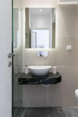 a bathroom with a sink and a mirror at Voda Luxury Residence Penthouse #601 - Acropolis View Rooftop in Athens