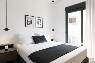 a bedroom with a large bed and a window at Voda Luxury Residence Penthouse #602 - Acropolis View Rooftop in Athens