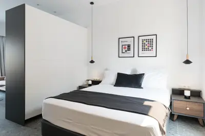 a bedroom with a large bed and two night stands at Voda Luxury Residence Penthouse #602 - Acropolis View Rooftop in Athens