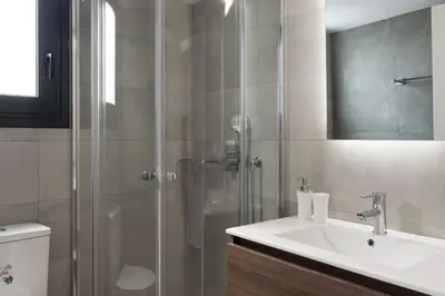 a bathroom with a shower and a sink and a toilet at Voda Luxury Residence Penthouse #602 - Acropolis View Rooftop in Athens