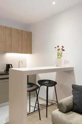 a kitchen with a white counter and two stools at Voda Luxury Residence #801 - Acropolis View Rooftop in Athens