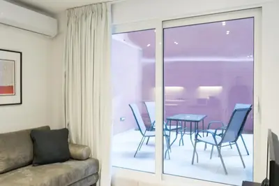 a living room with a couch and a table and chairs at Voda Luxury Residence #801 - Acropolis View Rooftop in Athens