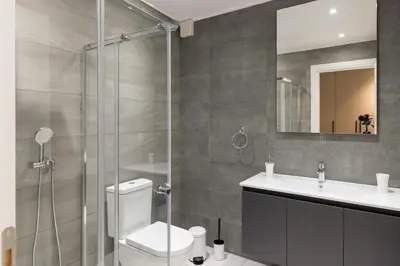 a bathroom with a shower and a toilet and a sink at Voda Luxury Residence #801 - Acropolis View Rooftop in Athens