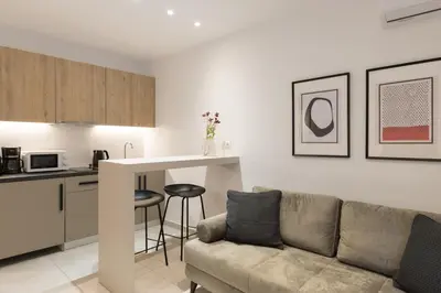 a living room with a couch and a kitchen at Voda Luxury Residence #801 - Acropolis View Rooftop in Athens