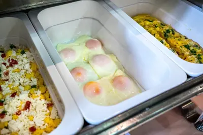 two trays of food with eggs and other foods at Emmantina Hotel in Athens