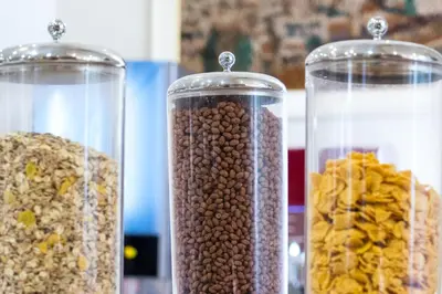 three glass containers filled with different types of beans at Emmantina Hotel in Athens