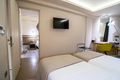 a bedroom with a bed and a television on the wall at Emmantina Hotel in Athens
