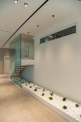 a lobby with a staircase and a glass wall at Emmantina Hotel in Athens