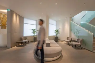 a man is walking through a hospital lobby at Emmantina Hotel in Athens