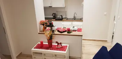 a small kitchen with a counter with red boots on it at B2 Acropolis in Athens