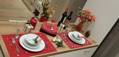 a table with white plates and red napkins and flowers at B2 Acropolis in Athens