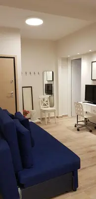 a living room with a blue couch and a piano at B2 Acropolis in Athens