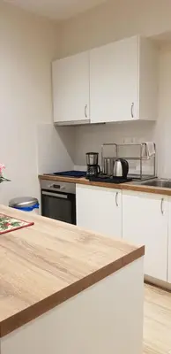 a kitchen with white cabinets and a counter top at B2 Acropolis in Athens