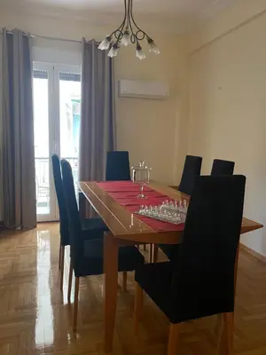 a dining room table with a chess board on it at Elegant Apartment in Athens