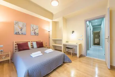 a bedroom with a bed and a desk and a door at Rest Sleep Repeat by museum-2 in Athens