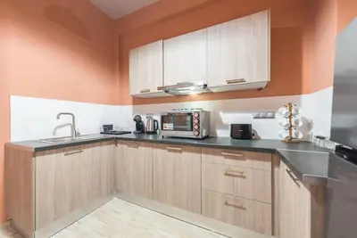 a kitchen with wooden cabinets and a microwave at Rest Sleep Repeat by museum-2 in Athens