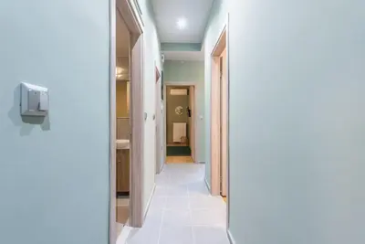 a hallway with a white tiled floor in a house at Rest Sleep Repeat by museum-2 in Athens