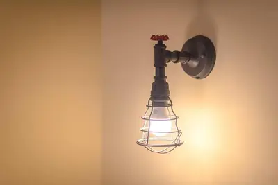 a light hanging on a wall with a lamp at Rest Sleep Repeat by museum-2 in Athens