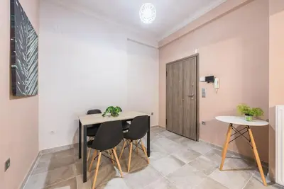 a dining room with a table and chairs and a door at Rest Sleep Repeat by museum-2 in Athens