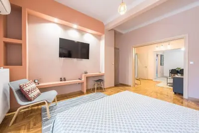 a bedroom with a bed and a tv on a wall at Rest Sleep Repeat by museum-2 in Athens