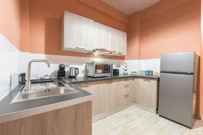 a kitchen with a sink and a refrigerator at Rest Sleep Repeat by museum-2 in Athens