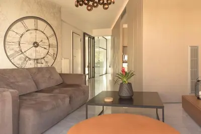 a living room with a couch and a table at Luxury Apt with Parking-Living Stone Silver in Athens
