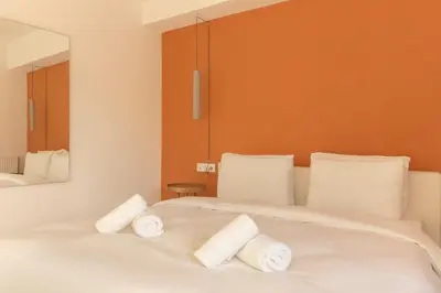 a bedroom with a white bed with towels on it at Luxury Apt with Parking-Living Stone Silver in Athens