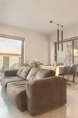 a living room with a brown couch and a table at Luxury Apt with Parking-Living Stone Silver in Athens