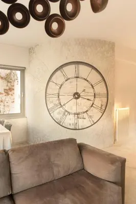 a large clock on a wall in a living room at Luxury Apt with Parking-Living Stone Silver in Athens