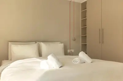 a white bed with two white pillows on it at Luxury Apt with Parking-Living Stone Silver in Athens