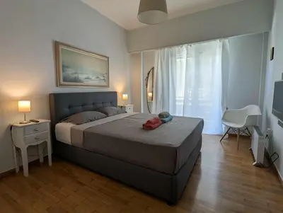 a bedroom with a large bed and a window at Spacious 2BA next to the park and Archeological museum in Athens