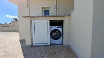 a washing machine sitting inside of a building at Studio with panoramic Athens view in Athens