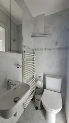 a white bathroom with a toilet and a sink at Studio with panoramic Athens view in Athens