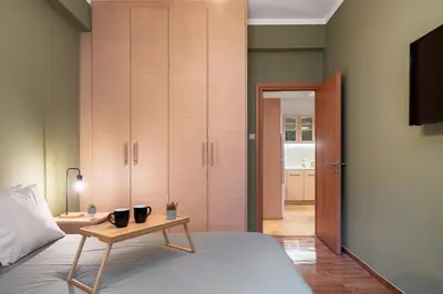 a bedroom with a bed and a table with cups on it at Plaka Apartment With Terrace View in Athens