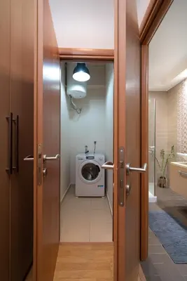 a bathroom with a washer and dryer in a room at Plaka Apartment With Terrace View in Athens