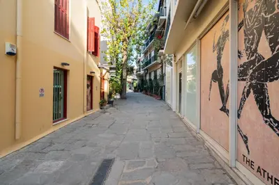 an empty street in an alley between buildings at Plaka Apartment With Terrace View in Athens