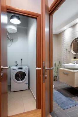 a bathroom with a washing machine and a sink at Plaka Apartment With Terrace View in Athens